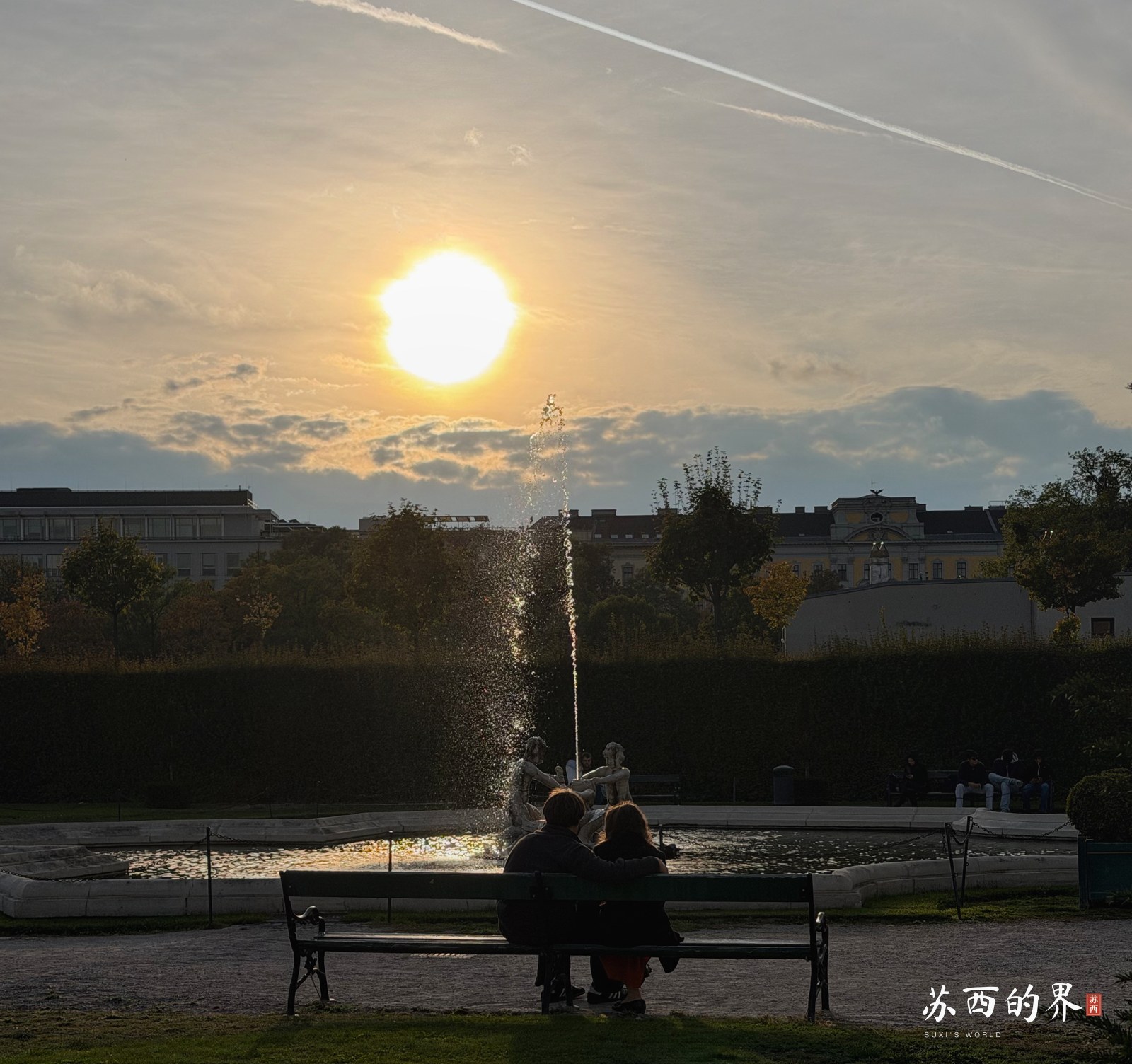 Sunset, fountain and bench.